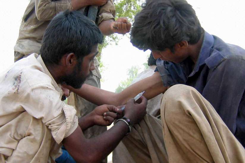 A Pakistani man injects a heroin-filled syringe into a man in 2011 on the streets in Multan. Pope Francis has requested a special study session at the Vatican to look at how to solve the growing problem of drug abuse, especially narcotics.