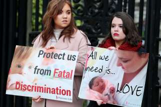 Pro-life supporters are seen in a 2019 file photo holding signs outside the High Court in Belfast, Northern Ireland. On June 2, 2020, politicians in Northern Ireland rejected an &quot;extreme&quot; new abortion law imposed on the province from Parliament in London.