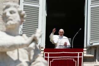 Pope Francis greets the crowd as he leads the Angelus from the window of his studio overlooking St. Peter&#039;s Square at the Vatican Aug. 15, 2019, the feast of the Assumption.