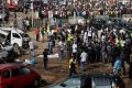 A crowd gathers at the scene of a bomb blast at a bus terminal on the outskirts of Abuja, Nigeria, April 14 that killed at least 71 people. The Catholic Church condemned the bombing and called for an end to violence, especially during Holy Week.