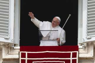 Pope Francis waves as he leads the Angelus in St. Peter&#039;s Square at the Vatican March 13.