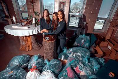 Loretto College School students Fiona Kazazi Cerkozi, Madison Scolieri and Monica Goncalves with the goods students collected for Ukraine.