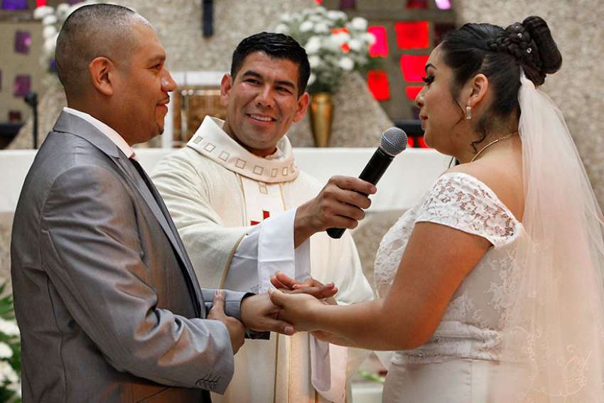 Father Manuel Dorantes, pastor, celebrates a marriage convalidation Mass in 2016 at Immaculate Conception Church in Chicago.