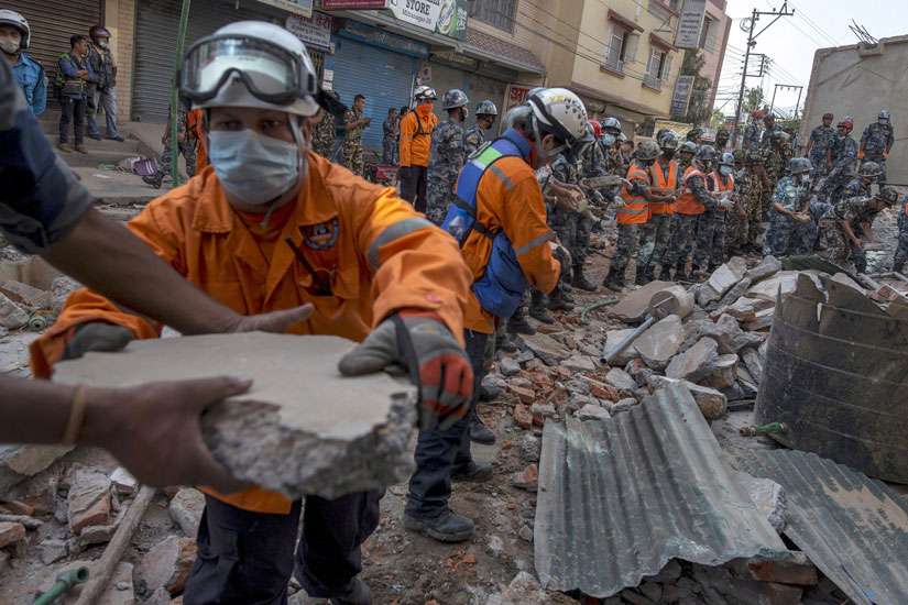 Nepalese military personnel remove debris in Kathmandu, Nepal, in search for survivors after an earthquake struck May 12. The magnitude-7.3 quake hit a remote mountainous region of Nepal that day, killing at least 19 people, triggering landslides and top pling buildings less than three weeks after the country was hit by its worst quake in decades.