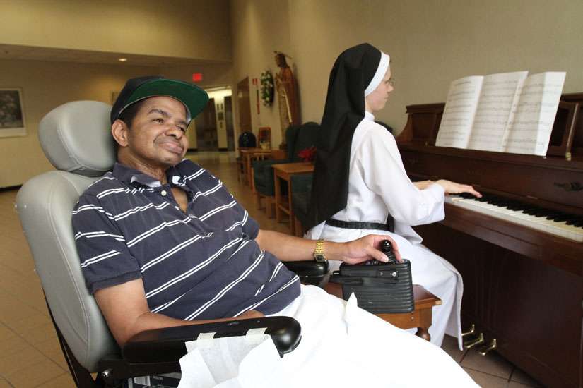The sponsors behind a bill to legalize physician-assisted suicide pulled it hours before a California state Assembly hearing July 7. Here, a palliative care patient smiles as a Dominican Sister plays the piano at a nursing home for people with incurable cancer.