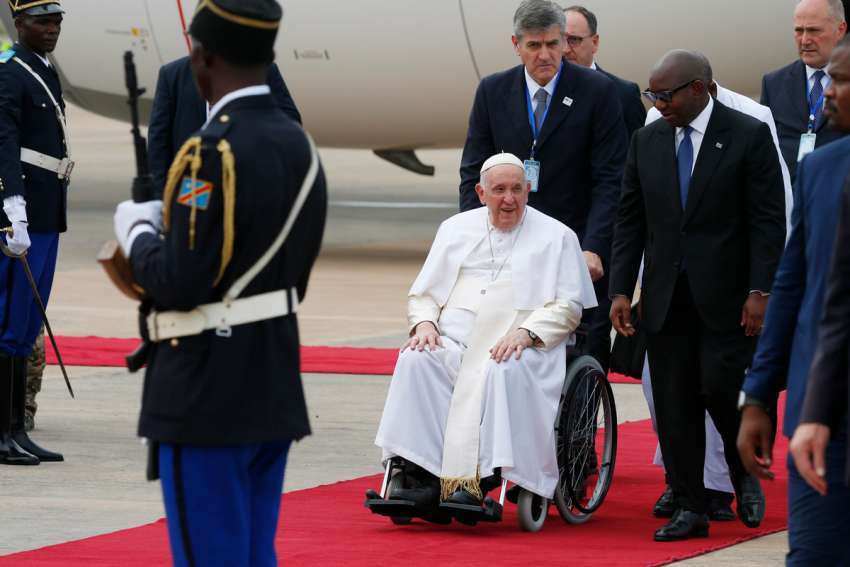 Pope Francis is welcomed by Prime Minister Sama Lukonde, right, as he arrives at the international airport in Kinshasa, Congo, Jan. 31, 2023.