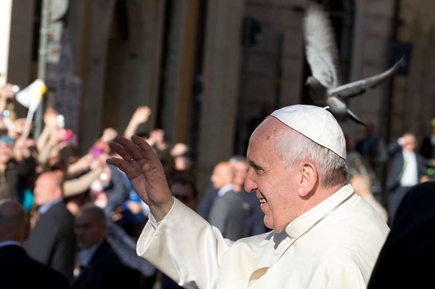 Pope Francis greets the crowd while arriving to celebrate Mass at the Church of St. Ignatius in Rome April 24, 2014. To mark the feast of St. Ignatius of Loyola, Pope Francis visited his brother Jesuits at their General Curia house in Rome.