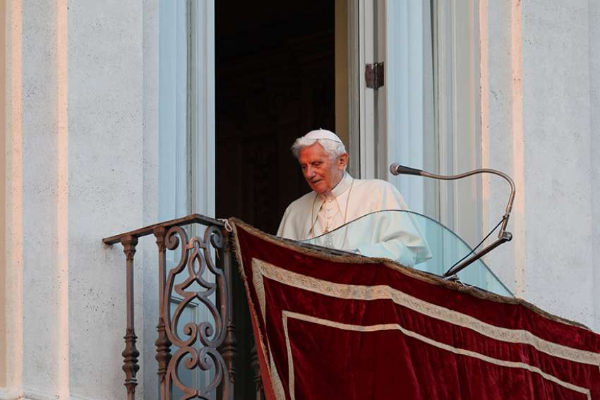 Pope Benedict XVI walks away after his final public appearance from the balcony of the papal villa in Castel Gandolfo, Italy, on the day of his resignation, in this Feb. 28, 2013.