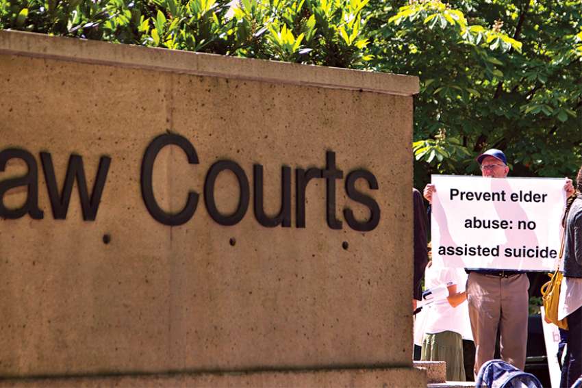 A protester from the Euthanasia Prevention Coalition, top, is pictured in a file photo outside the British Columbia Supreme Court.