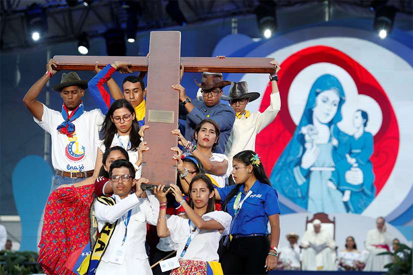 Pilgrims carry the World Youth Day cross as Pope Francis joins them in the Way of the Cross at Santa Maria la Antigua Field in Panama City Jan. 25, 2019. 