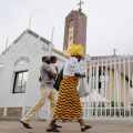 Worshippers arrive for Mass at Holy Trinity Catholic Church in Nigeria&#039;s capital, Abuja, June 24. Some churches in northern Nigeria, usually packed with worshippers, were almost empty and many people stayed away in other parts of the country after a week of violence. 