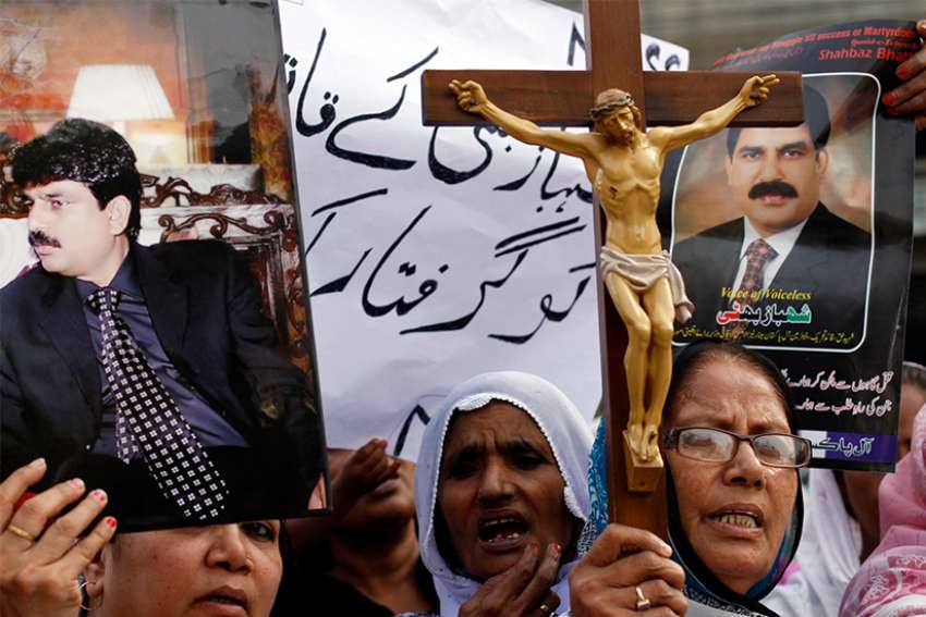 Christian women hold pictures of Shahbaz Bhatti, the slain Pakistani minister of minorities, as they demand a sentence for his killers during a protest in Karachi, Pakistan, April 6, 2011. 