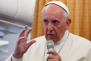 Pope Francis answers questions from journalists aboard his flight from Yerevan, Armenia, to Rome June 26.