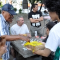 Brandan Tran, a participant in the July 13 Street Patrol, a weekly volunteer program to feed the poor and homeless of downtown Toronto, offers food to the homeless outside of the Metropolitan United Church. 