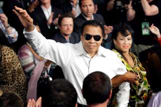 Boxing legend Muhammad Ali stands with his wife, Yolanda, as he is introduced before the 2010 welterweight fight between Floyd Mayweather Jr. and Shane Mosley at the MGM Grand Garden Arena in Las Vegas. Ali died June 3 at age 74 after a long battle with Parkinson&#039;s disease.