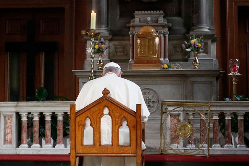 Pope Francis prays in front of a candle in memory of victims of sexual abuse as he visits St. Mary&#039;s Pro-Cathedral in Dublin Aug. 25, 2018.