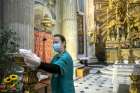 A worker disinfects before Mass at Rome&#039;s Basilica of Santa Maria in Campitelli May 18, 2020. The Pontifical Council for Culture at the Vatican distributed guidelines May 20 for cleaning and protecting church objects during the coronavirus pandemic.