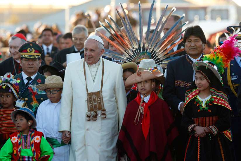 Pope Francis walks with Bolivian President Evo Morales and children in traditional dress as he arrives at El Alto International Airport in La Paz, Bolivia, July 8. The airport is over 4000 metres above sea level.