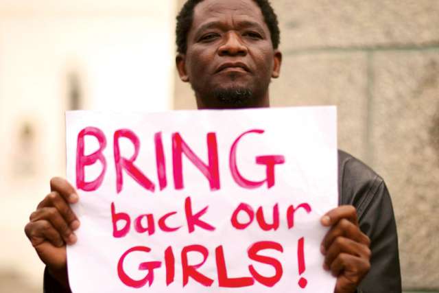 A protester holds a sign during a march in Cape Town, South Africa, in support of the girls kidnapped in Nigeria by Boko Haram.