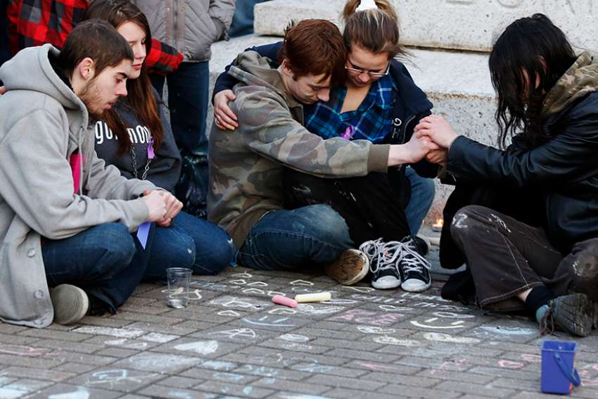  Teens comfort each other during a vigil for a friend who committed suicide. A Michigan priest, criticized for emphasizing suicide during a recent homily at a teenager&#039;s funeral, has apologized and said he &quot;fell well short&quot; of providing the family with the comfort they desperately needed. 