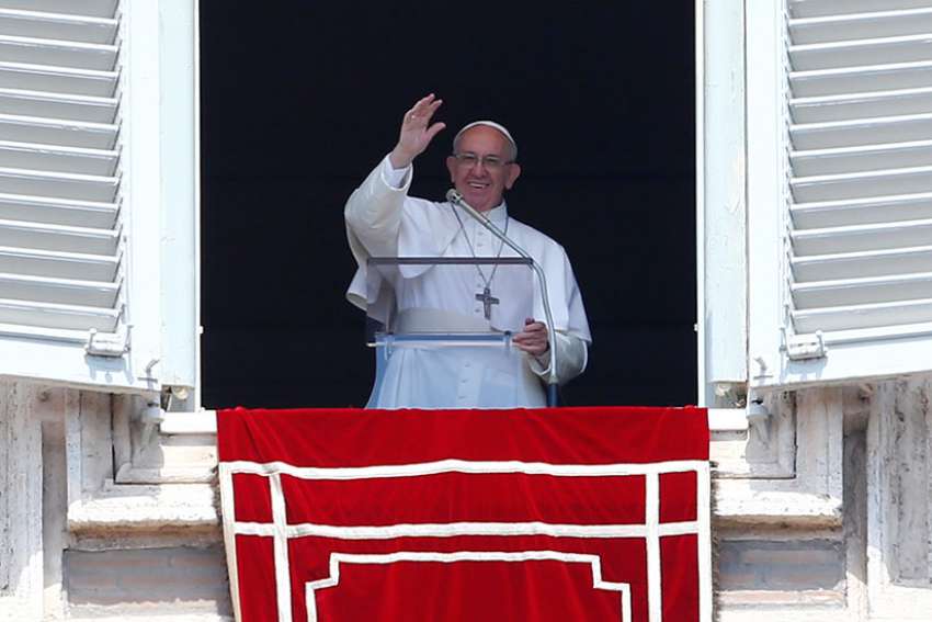 Pope Francis waves as he leads the Angelus from his studio overlooking St. Peter&#039;s Square at the Vatican April 23.