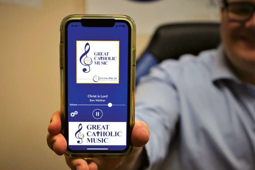 Program director Michael Roberts demonstrates the Great Catholic Music app.