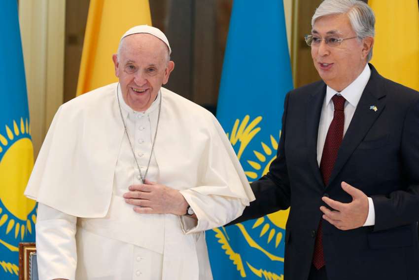 Pope Francis is welcomed by Kazakh President Kassym-Jomart Tokayev as he arrives at the international airport in Nur-Sultan, Kazakhstan, Sept. 13, 2022. The pope is attending the Congress of Leaders of World and Traditional Religions in Nur-Sultan.