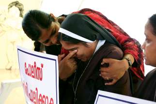 A woman religious is consoled during a protest in Cochin, India, demanding justice after a nun accused Bishop Franco Mulakkal of raping her. 