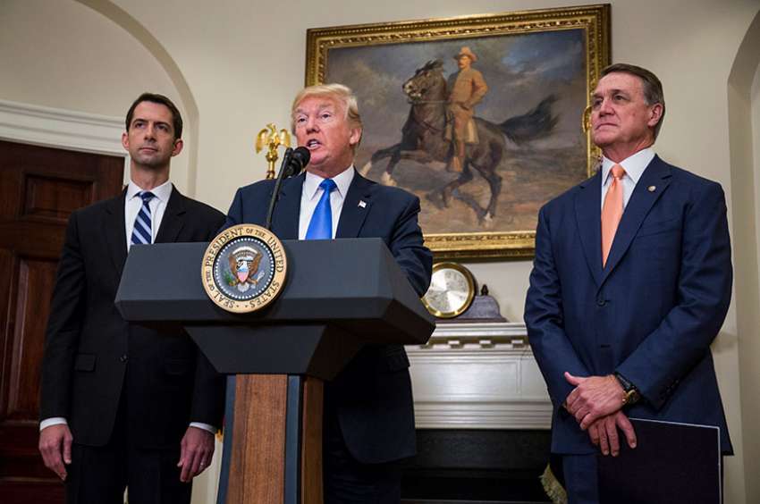  U.S. President Donald Trump makes an announcement on the introduction in the Senate of the Reforming American Immigration for Strong Employment Act, or RAISE, with Sens. Tom Cotton, R-Ark., and David Perdue, R-Ga., at the White House Aug. 2. 