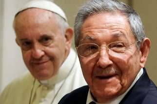 Cuban President Raul Castro, right, smiles as he meets Pope Francis during a private audience at the Vatican on May 10, 2015.