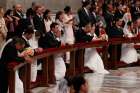 Newly married couples kneel as Pope Francis celebrates the marriage rite for 20 couples during a Mass in St. Peter&#039;s Basilica at the Vatican Sept. 14. 