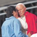 Pope John Paul II hugs a young woman during the closing Mass for World Youth Day in Denver in this Aug. 15, 1993, file photo. 