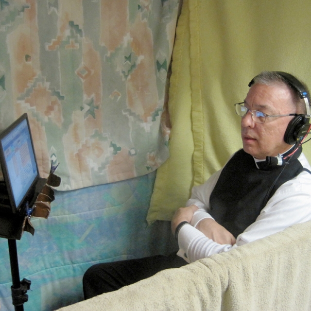 Fr. Peter Stravinskas is pictured in early July in a recording booth display at Faith Comes By Hearing in Albuquerque, N.M. 