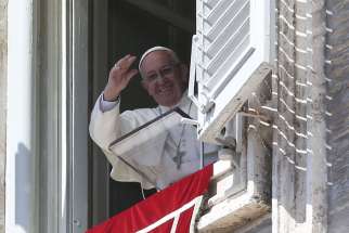 Pope Francis waves as he leads his Angelus prayer from the window of his studio overlooking St. Peter&#039;s Square at the Vatican April 10.