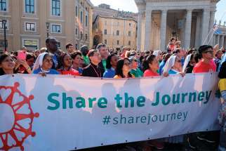  Cardinal Luis Antonio Tagle of Manila, Philippines, and other participants in the &quot;Share the Journey&quot; walk arrive near the Vatican Oct. 21. The campaign and 1.5-mile walk were organized by Caritas Internationalis to call attention to the plight of migrants and refugees.