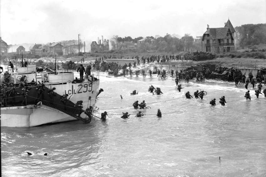 Troops of the 9th Canadian Infantry Brigade leave their landing craft to go ashore at Bernières-sur-mer, Normandy, on D-Day, June 6, 1944.