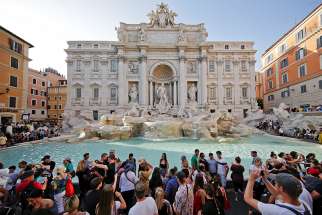 Tourists stand at Rome&#039;s Trevi Fountain Aug. 2, 2017.