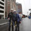 Benedictine Sisters Jennifer Mechtild Horner and Sheila Fitzpatrick pose Jan. 26 under an 800-foot zip line that they just rode that was built over Capitol Avenue in Indianapolis in the middle of the Super Bowl Village and next to St. John the Evangelist Church.