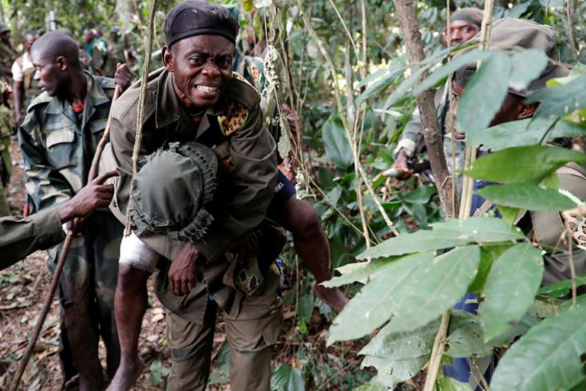 A wounded soldier from the Congolese armed forces is carried Feb. 19 near the town of Kimbau, Congo. 