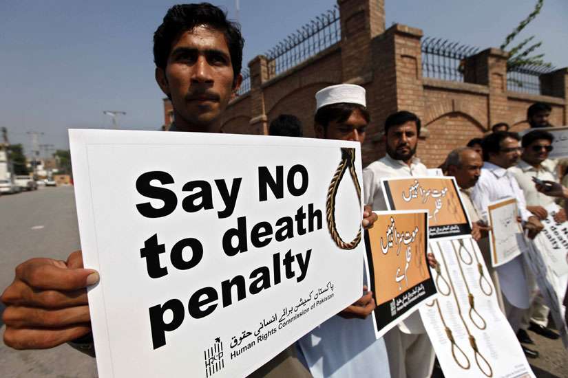Human rights activists hold placards during a rally in early October against the death penalty in Peshawar, Pakistan.