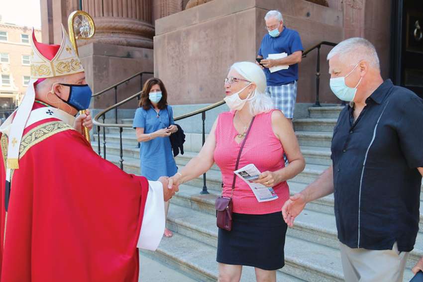 Philadelphia Archbishop Nelson J. Pérez greets worshippers after Mass May 23 outside the Cathedral Basilica of SS. Peter and Paul.