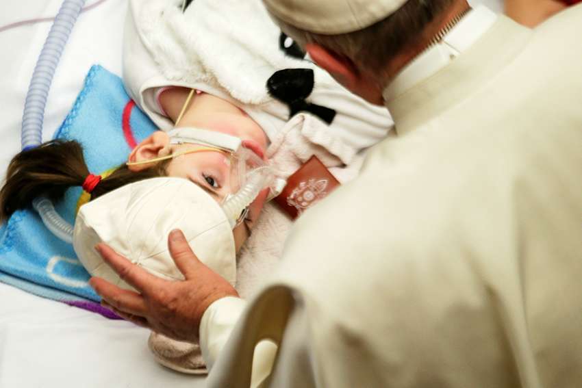 Pope Francis blesses a sick child in Paul VI hall at the Vatican Dec. 15, 2016, during a meeting with patients and workers of Rome&#039;s Bambino Gesu children&#039;s hospital.