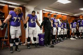 Baltimore Ravens head coach John Harbaugh prays with players after they defeated the Cleveland Browns 20-10 in 2014 at M&amp;T Bank Stadium in Baltimore. Harbaugh says he has relied on his Catholic faith to guide him and his players as they have faced various challenges during the past year. 