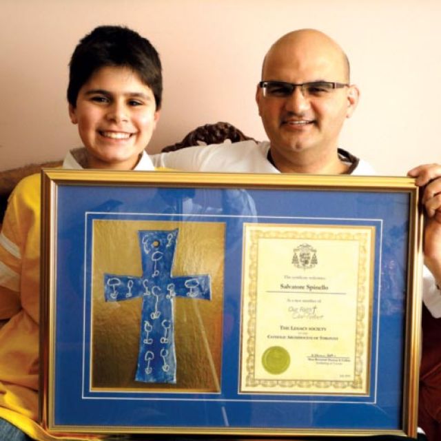 Sam Spinello, right, and Joseph proudly display their Legacy Society cross and certificate signed by Cardinal Thomas Collins. Sam was so pleased that he had it specially framed.