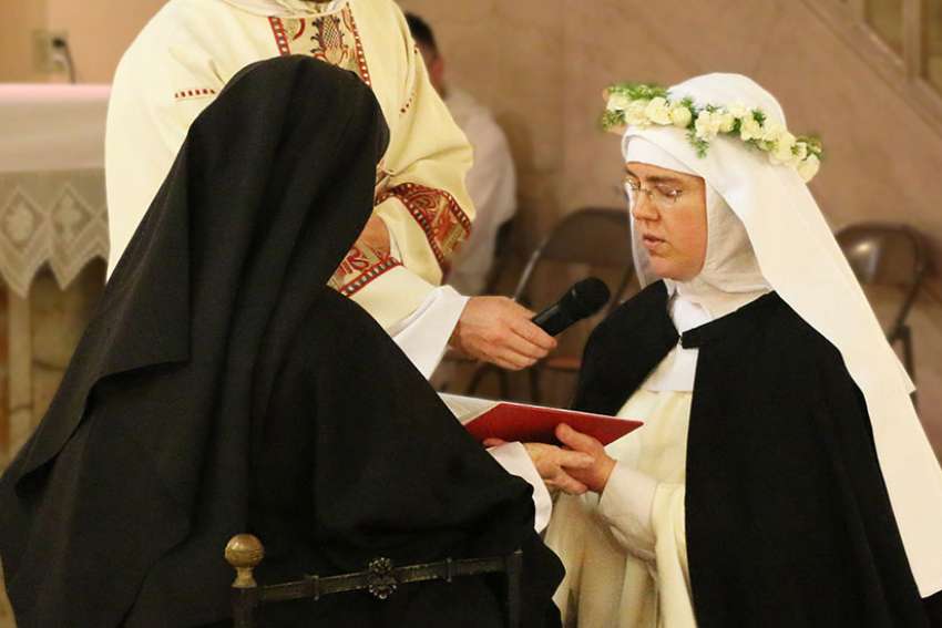 Sister Marie Dominic, right, professes her first vows as a cloistered nun May 28 at Corpus Christi Monastery in Menlo Park, Calif. Sister Marie Dominic was an attorney and an evangelical Christian in Anchorage, Alaska, who joined the Catholic Church during her last months of law school.