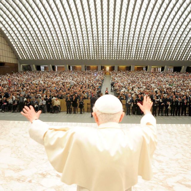 Pope Benedict XVI waves as he arrives to lead an audience with Christian volunteers in Paul VI Hall at the Vatican May 19.