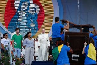 Pope Francis watches as young people carry the World Youth Day cross and icon during a welcoming ceremony and gathering with young people in Santa Maria la Antigua Field in Panama City Jan. 24, 2019. 