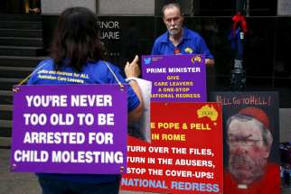 Victims and relatives of children who claim they were sexually abused by the Catholic Church hold placards as they stand outside the venue for Australia&#039;s Royal Commission Into Institutional Responses to Child Sexual Abuse in Sydney Feb. 29.