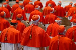 Cardinals attend the Good Friday service led by Pope Francis in St. Peter&#039;s Basilica at the Vatican in this March 30 file photo. The pope announced May 20 that he will create 14 new cardinals at a June 29 consistory.