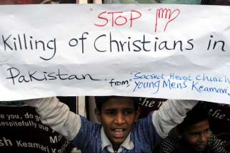 A Pakistani Christian boy holds a banner during a late March protest in Karachi after attacks on churches in Lahore. The U.S. State Department&#039;s annual report on the status of religious freedom around the world was released in Washington Oct. 14.